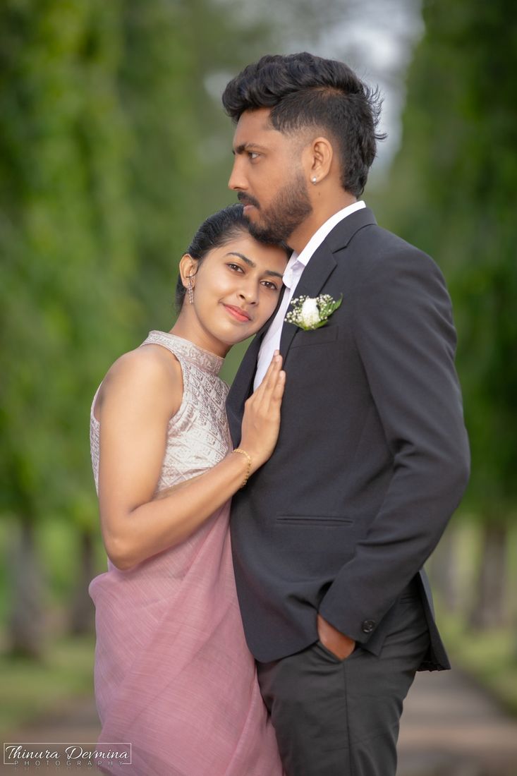 Couple embracing in a tree-lined avenue